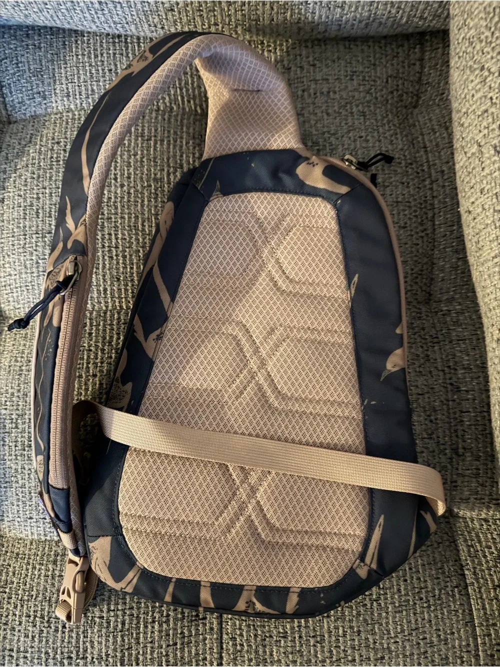 Patagonia sling pack in navy blue with tan accents